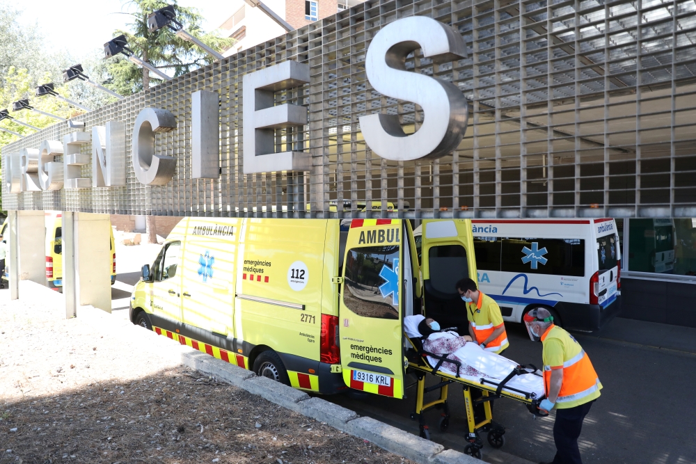 A woman is carried on a stretcher at Arnau de Vilanova hospital, after Catalonia's government imposed new restrictions in an effort to control a new outbreak of the coronavirus disease (COVID-19), in Lleida, Spain July 4, 2020. Reuters/Nacho Doce