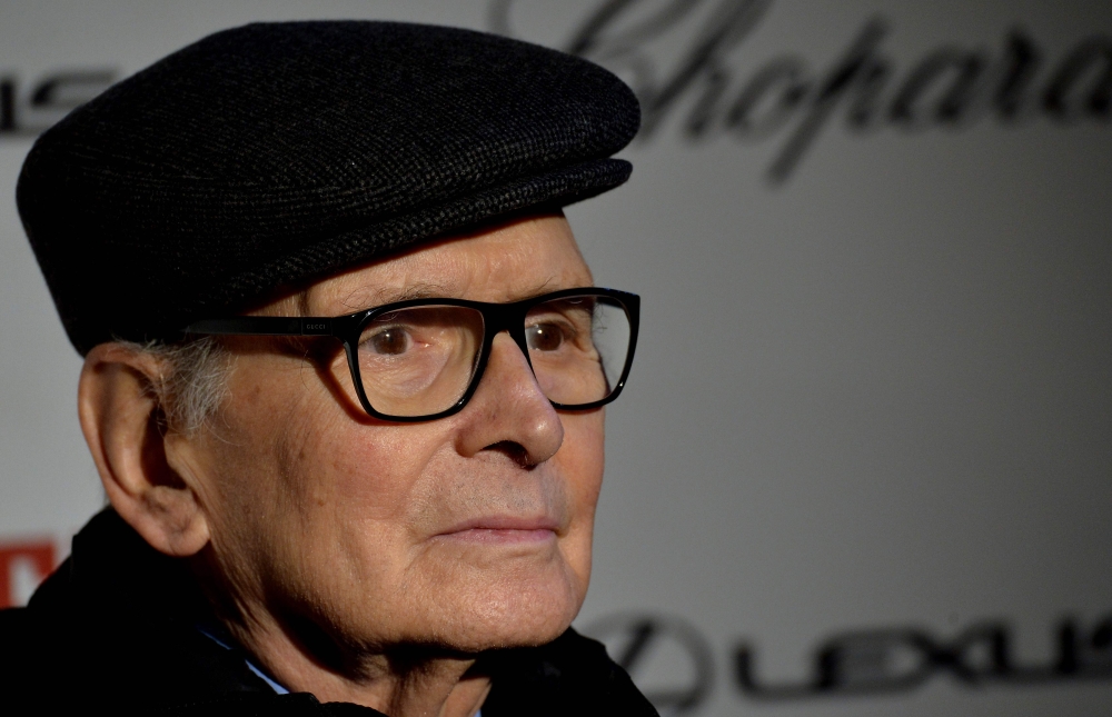 In this file photo taken on January 28, 2016, Italian composer Ennio Morricone poses as he arrives for the premiere of the film 'The Hateful Eight' in Rome. Ennio Morricone, one of the world's best-known and most prolific film composers, has died in Rome,