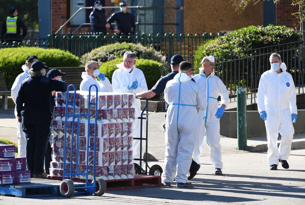 Response personnel prepare to distribute goods to residents inside a public housing tower, locked down in response to an outbreak of the coronavirus disease (COVID-19), in Melbourne, Australia, July 9, 2020. AAP Image/James Ross via Reuters