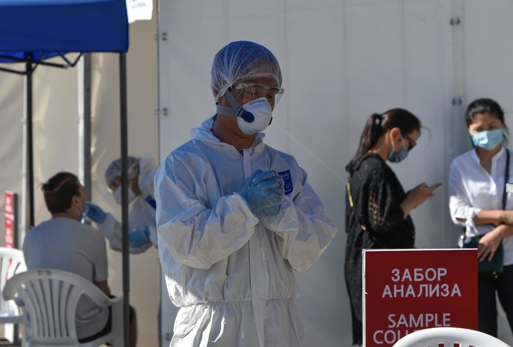 Medical specialists wearing protective equipment work at the coronavirus disease (COVID-19) testing facility in Almaty, Kazakhstan July 8, 2020. REUTERS/Mariya Gordeyeva
