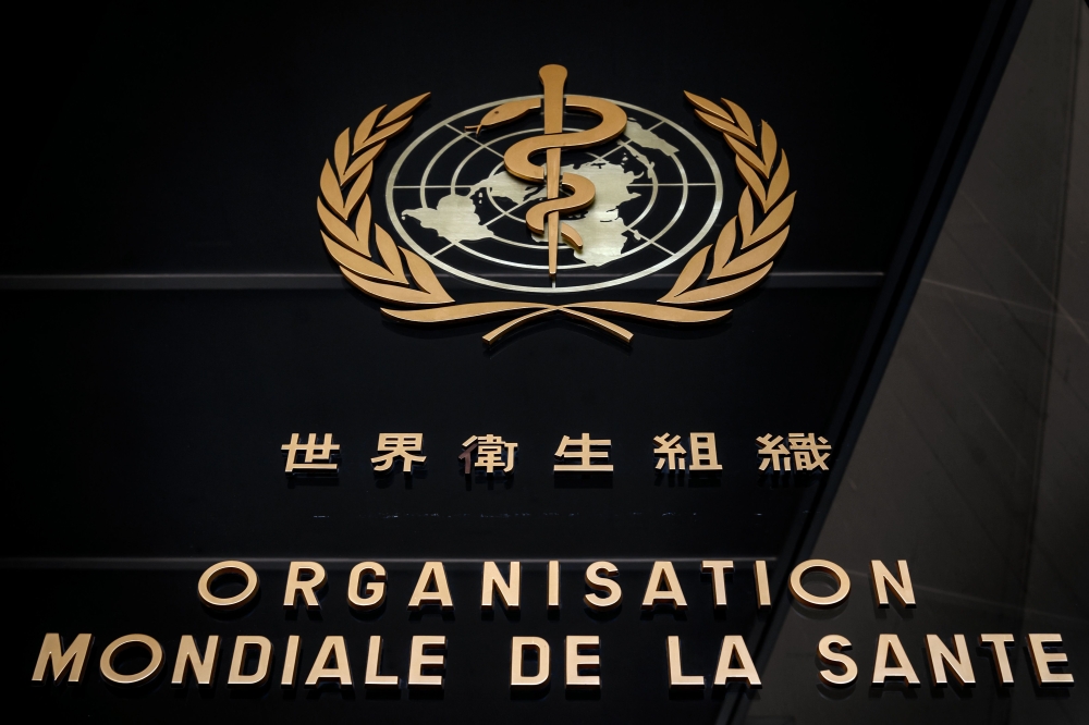 (FILES) This file photo taken on February 24, 2020 shows the logo of the World Health Organization (WHO) written in French and Chinese at the entrance of their headquarters in Geneva. / AFP / Fabrice COFFRINI
