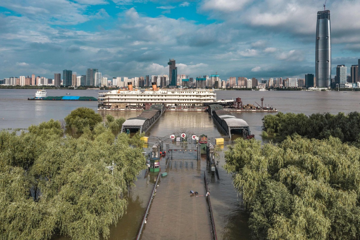 This overview taken on July 8, 2020 shows streets and walkways that lead to a dock inundated by floodwaters from the swollen Yangtze River following seasonal rains in Wuhan in China's central Hubei province. / AFP / STR