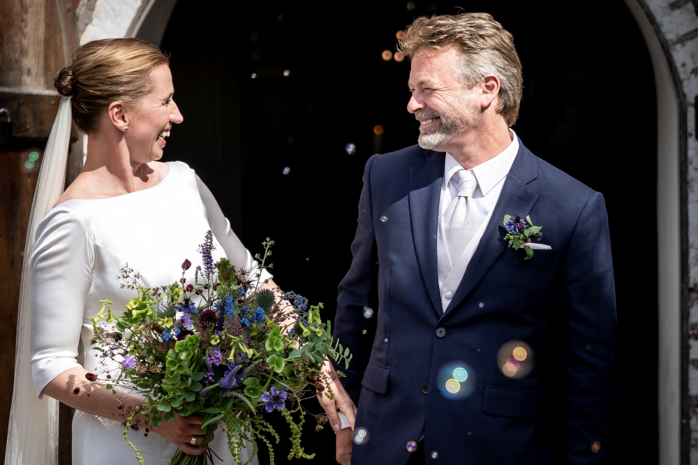 Danish Prime Minister Mette Frederiksen and her husband Bo Tengberg smile after getting married in Magleby Church, in Magleby, Denmark July 15, 2020. Ritzau Scanpix/via REUTERS