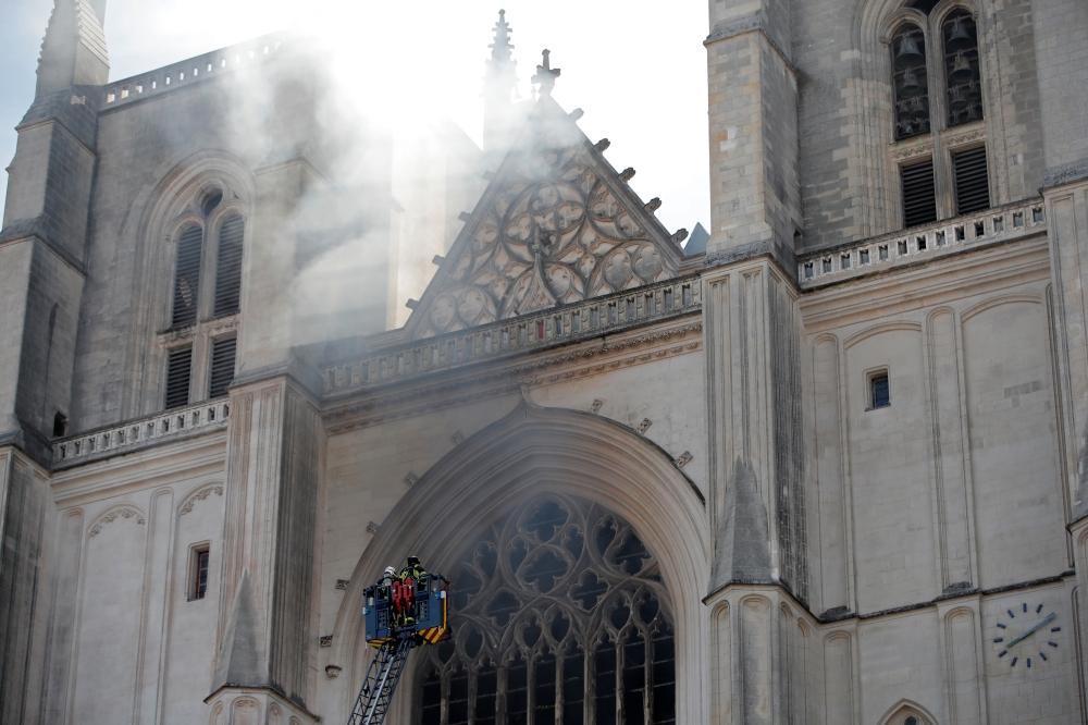 French firefighters battle a blaze at the Cathedral of Saint Pierre and Saint Paul in Nantes, France, July 18, 2020. REUTERS/Stephane Mahe
 