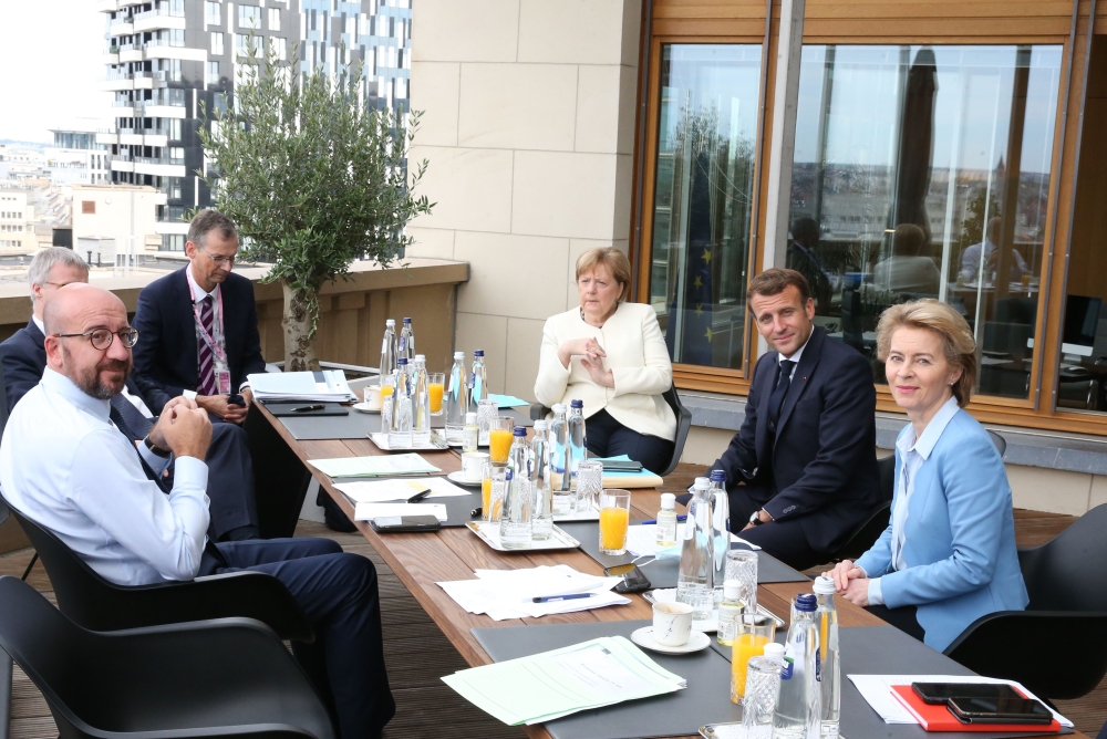 President of the European Council Charles Michel (L), Germany's Chancellor Angela Merkel (C), France's President Emmanuel Macron (2nd R) and President of the European Commission Ursula von der Leyen pose during a bilateral meeting at the EU summit on a co