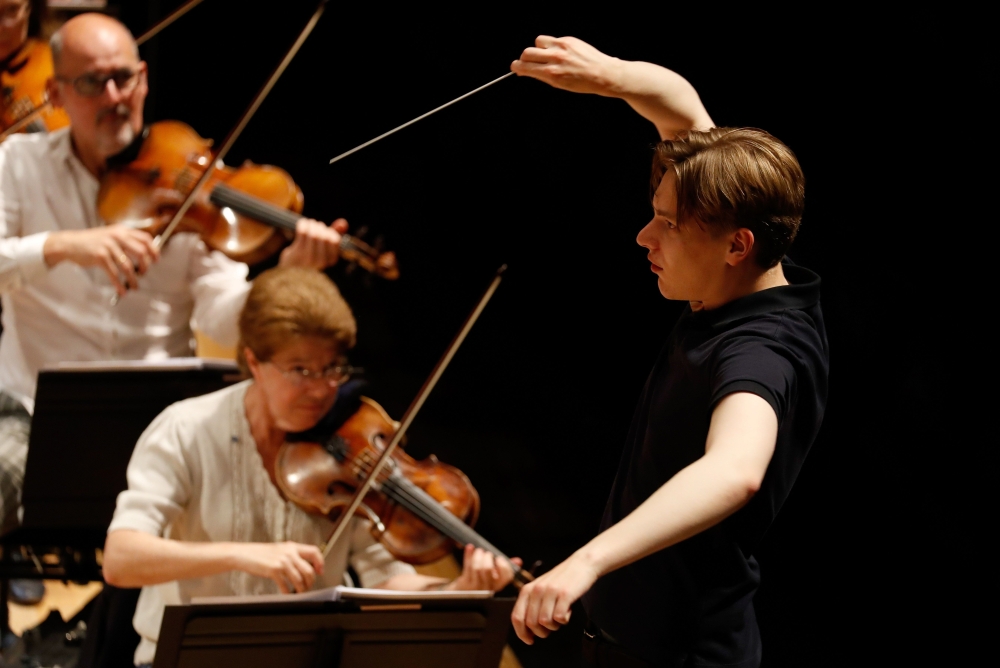 In this file photo taken on July 7, 2020, Finnish conductor Klaus Makela conducts the Paris' Orchestra during a rehearsal at The Philharmonie de Paris concert hall in Paris. He is the new wunderkind of classical music. At only 24, the young Finn Klaus Mak