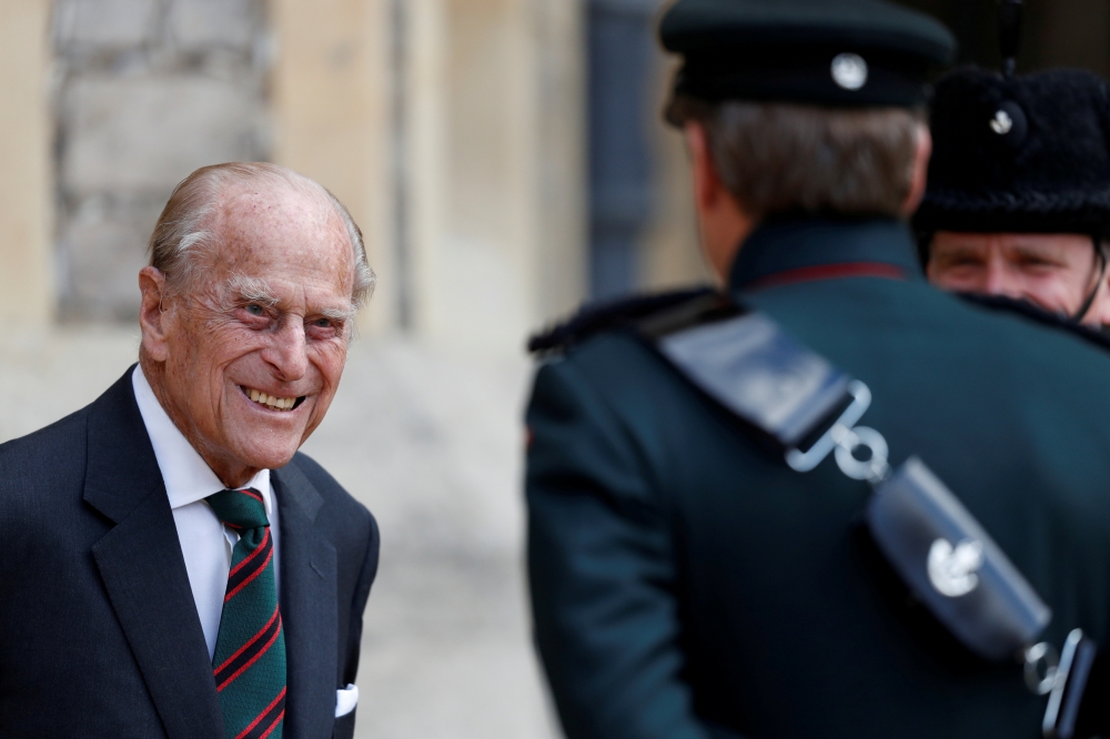 Britain's Prince Philip speaks to Assistant Colonel Commandant, Major General Tom Copinger-Symes during the transfer of the Colonel-in-Chief of the Rifles at Windsor Castle in Britain July 22, 2020. The Duke of Edinburgh will step down from his role as Co