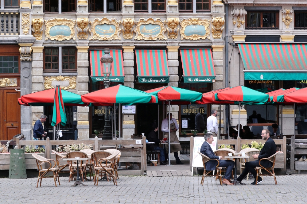 People sit on a terrace as restaurants and bars reopen after weeks of lockdown restrictions amid the coronavirus disease (COVID-19) outbreak, in Brussels, Belgium, June 8, 2020. REUTERS/Yves Herman/File Photo