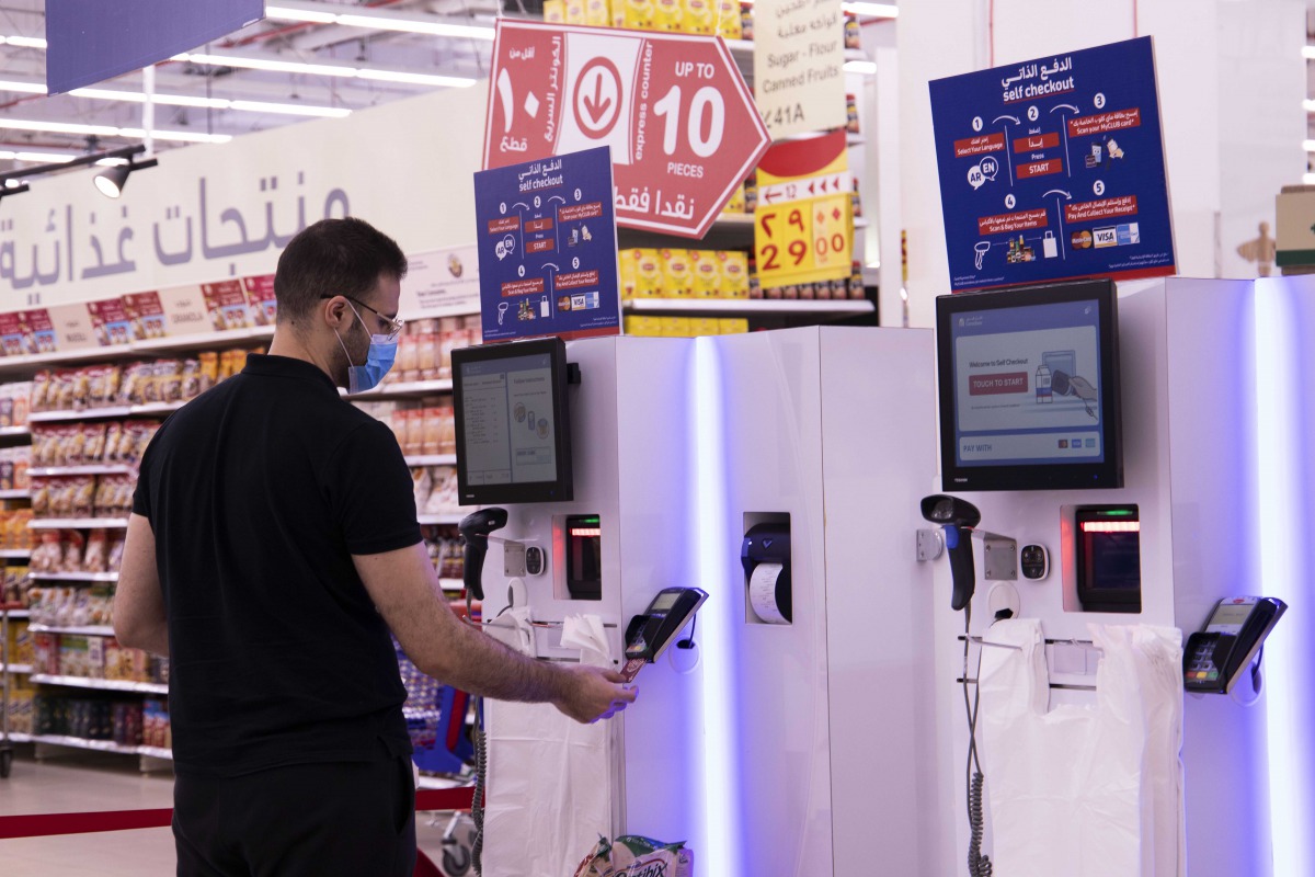 A customer using the self-check out counter.