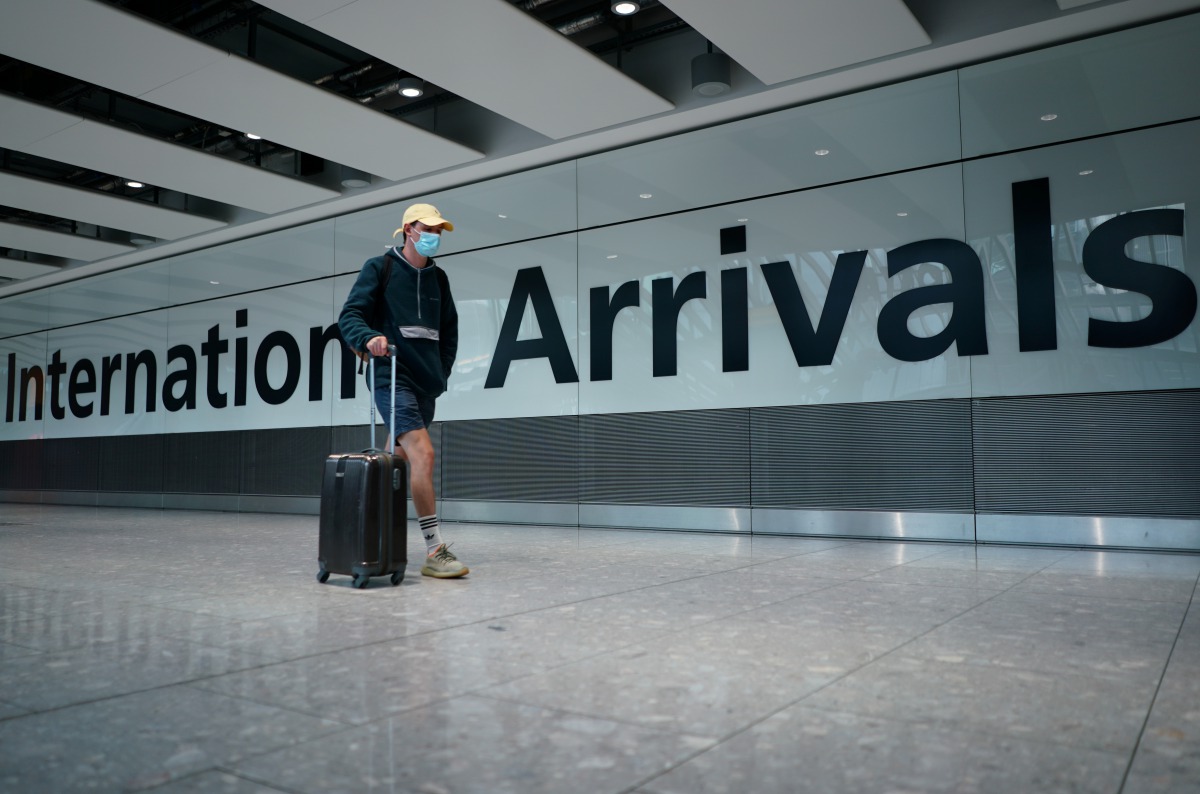 A traveller wearing a face mask walks at the Terminal 5 at Heathrow Airport, as the spread of the?coronavirus?disease (COVID-19) continues, in London, Britain, July 26, 2020. REUTERS/Henry Nicholls
