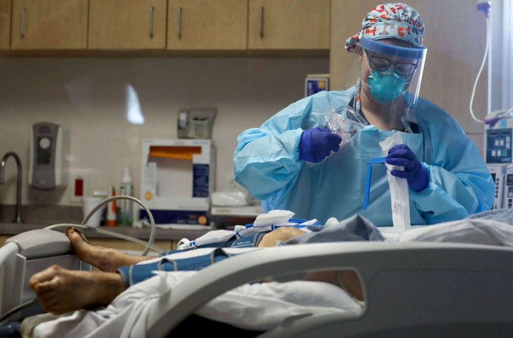 A nurse cares for a coronavirus (COVID-19) patient in the Intensive Care Unit (ICU) at El Centro Regional Medical Center in hard-hit Imperial County on July 28, 2020 in El Centro, California.