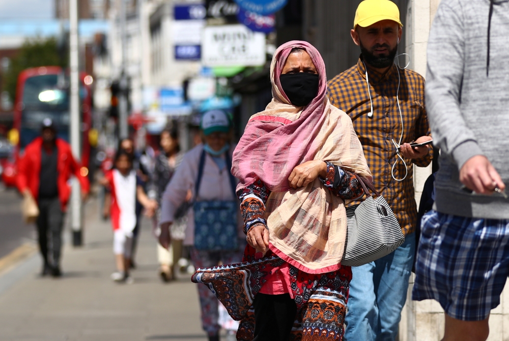 People walk down a street following the coronavirus disease (COVID-19) outbreak, in Ilford, London, Britain July 29, 2020. REUTERS/Hannah McKay