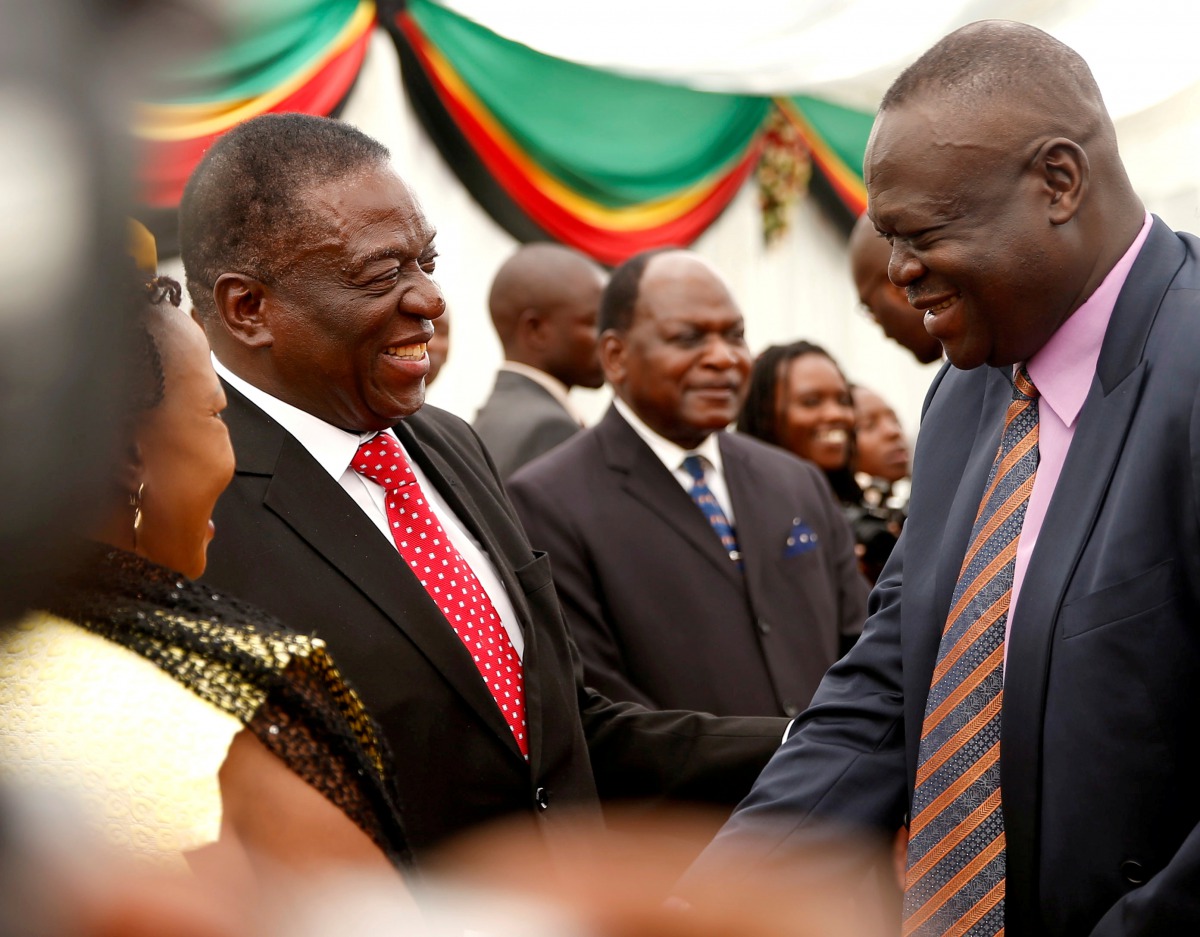 FILE PHOTO: Zimbabwean President Emmerson Mnangagwa congratulates Perrance Shiri, the new minister of Land, Agriculture and Land Resettlement are seen after the swearing in of cabinet ministers at State House in Harare, Zimbabwe December 4, 2017. REUTERS/