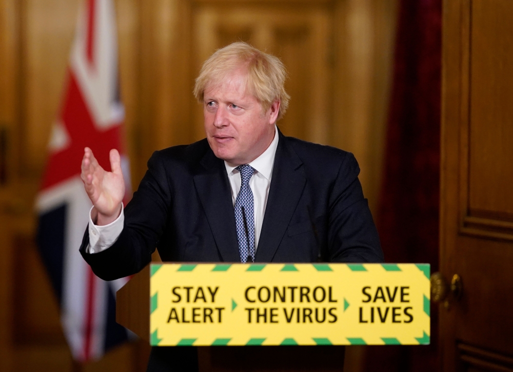  handout image released by 10 Downing Street, shows Britain's Prime Minister boris Johnson attending a remote press conference to update the nation on the novel coronavirus COVID-19 pandemic inside 10 Downing Street in central London on July 31, 2020. Bri