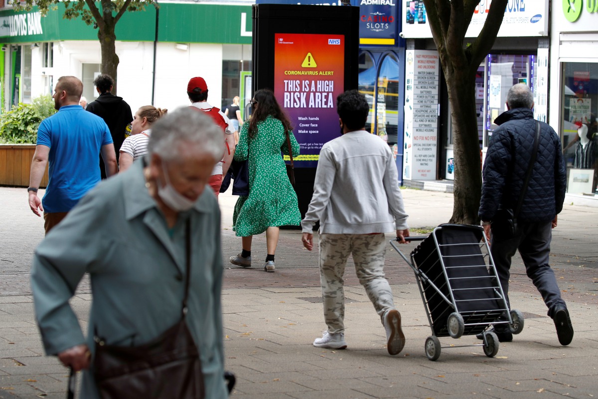 People walk along a street in the Sale area of Manchester, as the city and the surrounding area faces local restrictions in an effort to avoid a local lockdown being forced upon the area, amid the coronavirus disease (COVID-19) outbreak, Britain, August 1