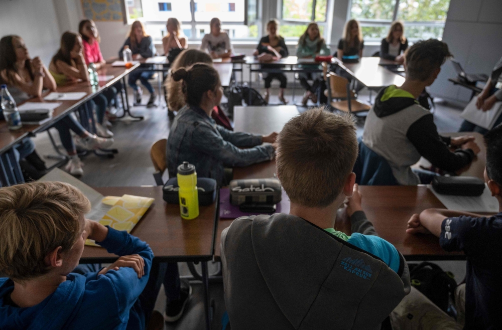 Students attend class at the Christophorusschule school in Rostock, northern Germany, on August 3, 2020, as school resumed after the summer break in the German state of Mecklenburg-Vorpommern (Mecklenburg-Western Pomerania), amid a Coronavirus Covid-19 pa