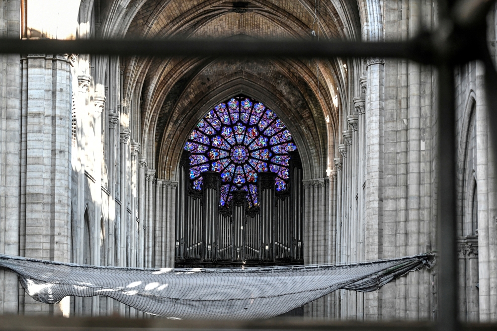 FILE PHOTO: The organ is pictured during preliminary work in the Notre-Dame Cathedral, three months after a major fire, in Paris, France July 17, 2019. Stephane de Sakutin/Pool via REUTERS/File Photo