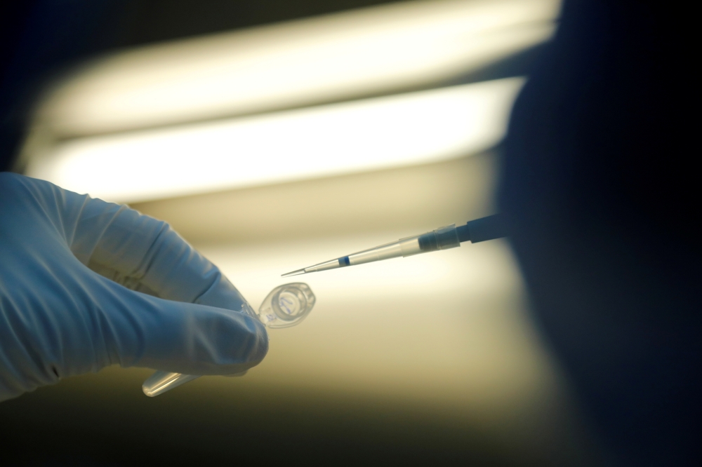 FILE PHOTO: A scientist prepares samples during the research and development of a vaccine against the coronavirus disease (COVID-19) at a laboratory of BIOCAD biotechnology company in Saint Petersburg, Russia June 11, 2020. REUTERS/Anton Vaganov/File Phot