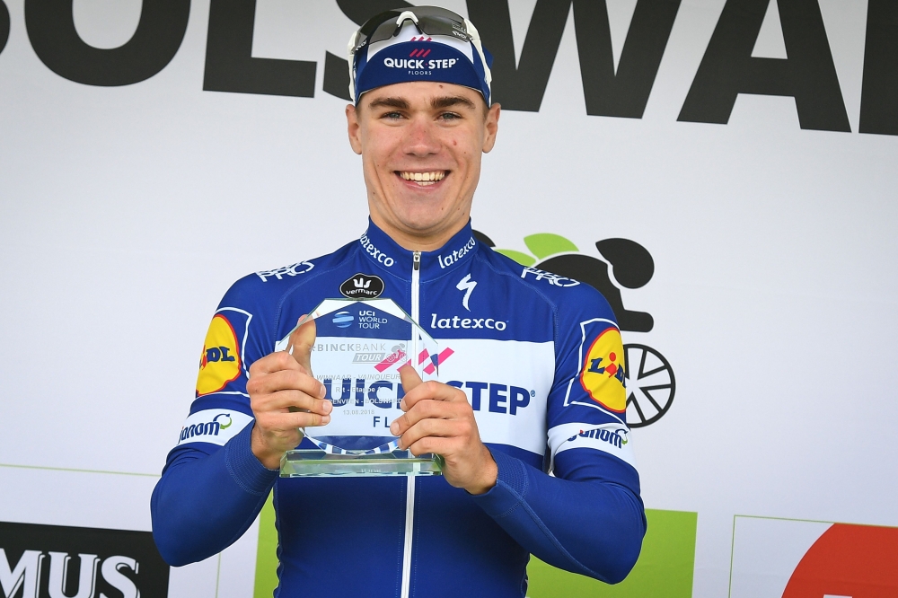 In this file photo taken on August 13, 2018 Dutch Fabio Jakobsen of Quick-Step Floors celebrates on the podium after winning the first stage of the Binkcbank Tour cycling race, 177.3 kilometres from Heerenveen to Bolsward. The Netherlands' Fabio Jakobsen 