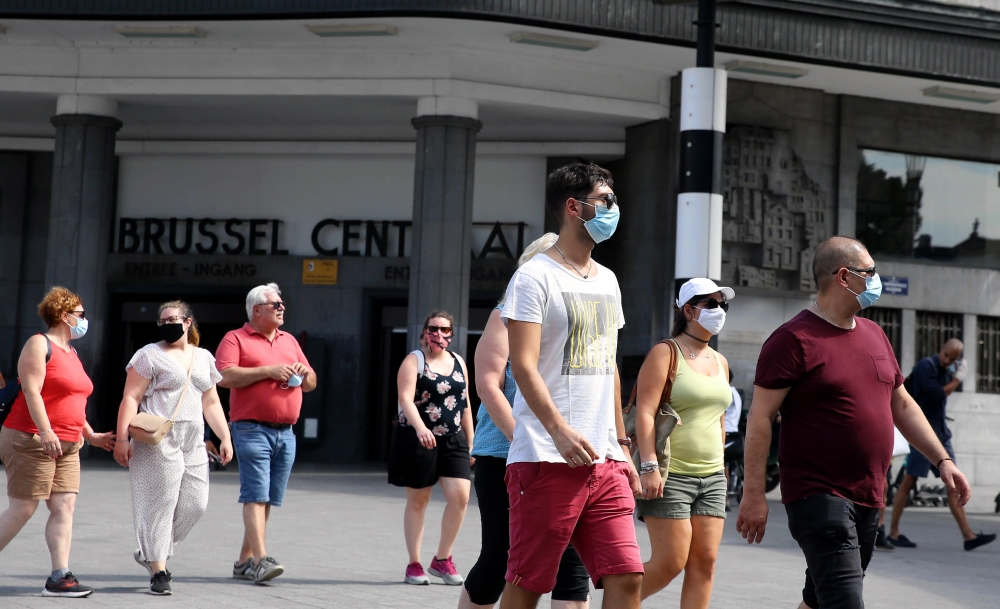 People wearing masks walk at a street as the novel coronavirus (COVID-19) cases have reached to 73,401 on August 09, 2020, in Brussels, Belgium.  Dursun Aydemir - Anadolu