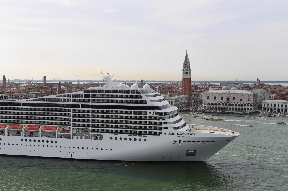 In this file photo taken on June 9, 2019 The MSC Magnifica cruise ship is seen from San Maggiore's bell tower leaving in the Venice Lagoon.  / AFP / Miguel MEDINA