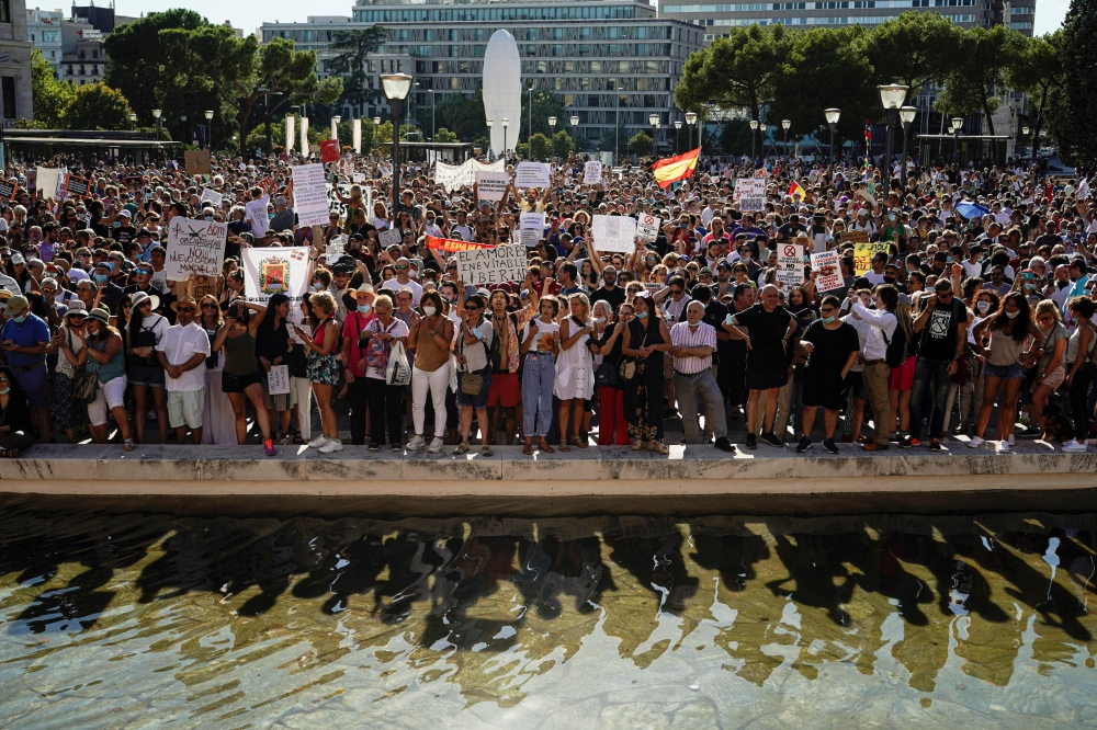 People take part in a protest against the use of protective masks during the coronavirus disease (COVID-19) pandemic, in Madrid, Spain August 16, 2020. REUTERS/Juan Medina