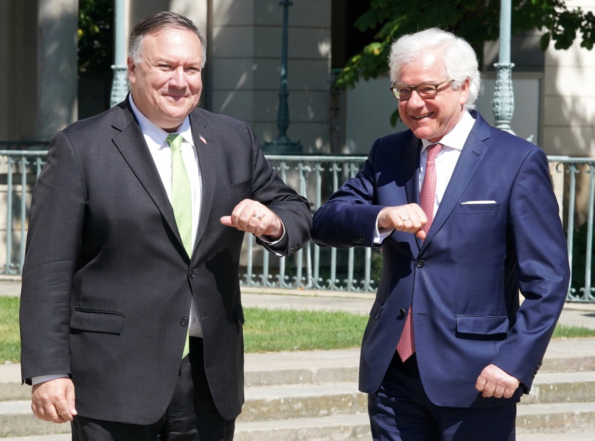 U.S. Secretary of State Mike Pompeo and Polish Foreign Minister Jacek Czaputowicz greet each other with an elbow bump in Lazienki Palace in Warsaw, Poland, August 15, 2020. Janek Skarzynski/Pool via REUTERS