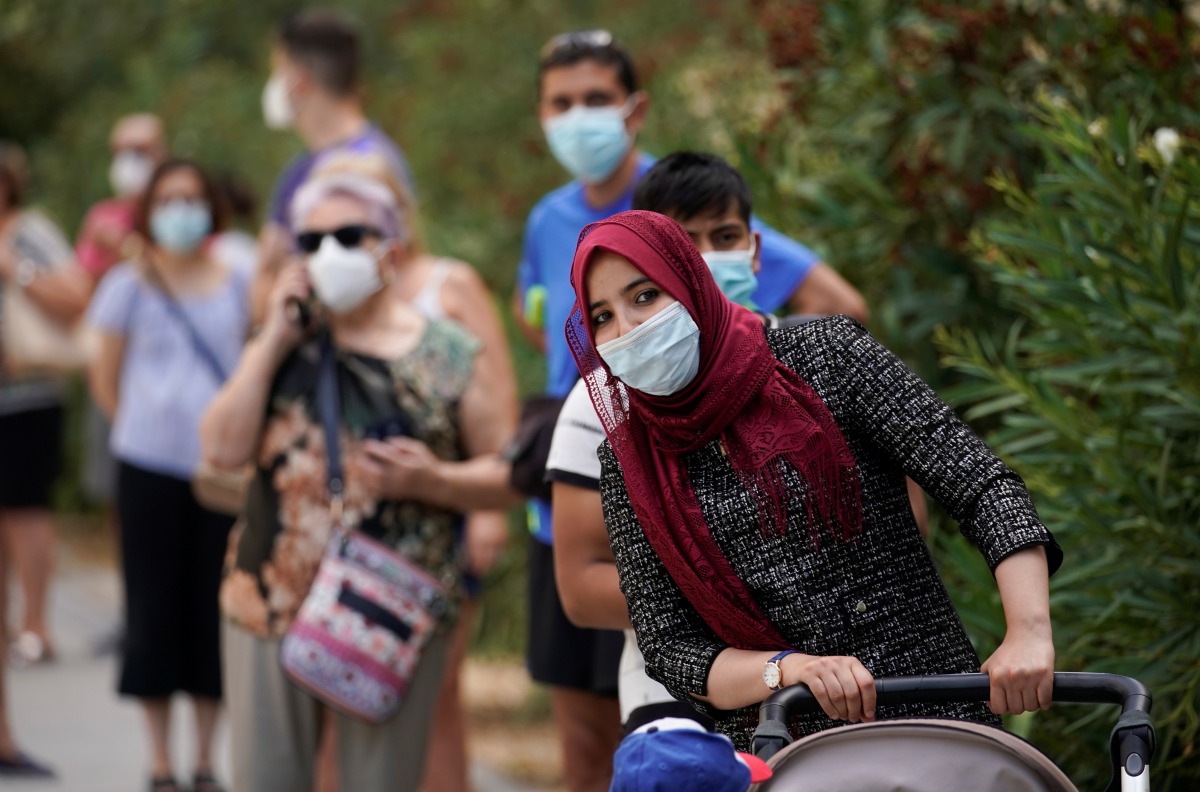 People queue to make PCR test outside at Federica Montseny primary health care center during the coronavirus disease (COVID-19) pandemic in Madrid, Spain, August 20, 2020. REUTERS/Juan Medina
