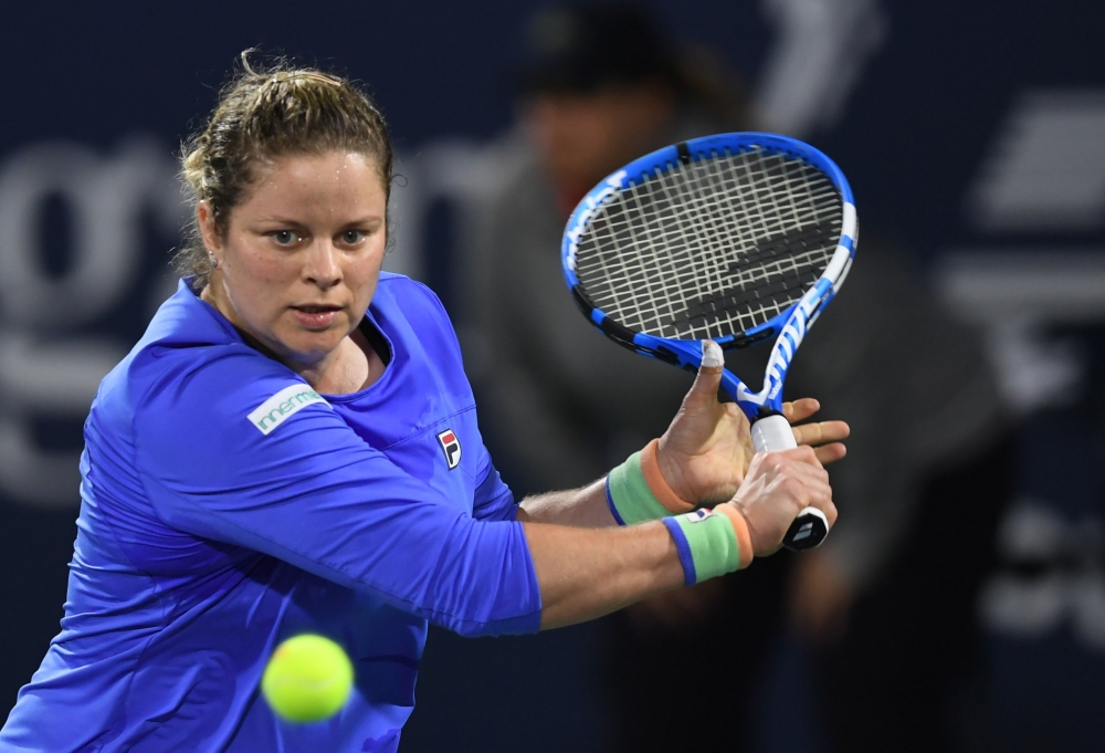 In this file photo taken on February 17, 2020, Kim Clijsters of the Belgium returns the ball to Garbine Muguruza of Spain during the WTA Dubai Duty Free Tennis Championship, at the Dubai Tennis Stadium in the United Arab Emirates. Kim Clijsters suffered a