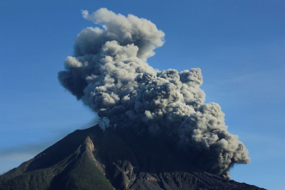Mount Sinabung volcano spews volcanic material as seen from Tiga Pancur village in Karo, North Sumatra province, Indonesia, August 23, 2020, in this photo taken by Antara Foto. Antara Foto/Edy Regar/via REUTERS