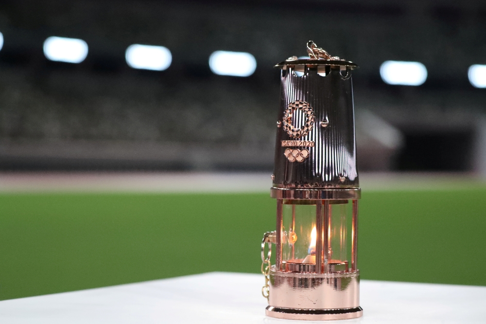 The Olympic flame in a lantern is seen after the 