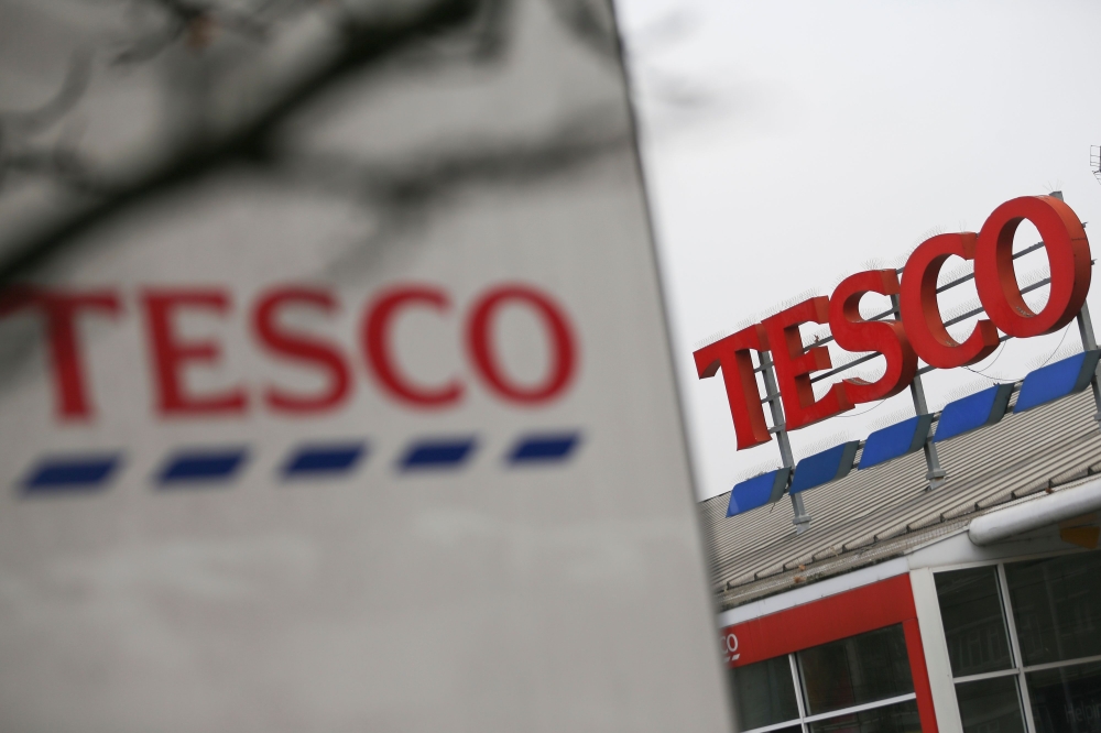 In this file photo taken on January 27, 2017 signage for a branch of a Tesco in London is pictured. Supermarket giant Tesco said Monday, August 24, it will create 16,000 permanent UK jobs to meet soaring online demand for groceries triggered by the corona