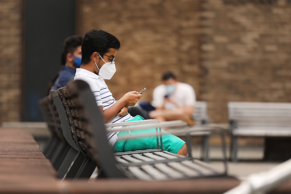 Students at New York University (NYU) wait outside of a Covid-19 test tent outside of its business school on August 25, 2020 in New York City. Spencer Platt/AFP  
