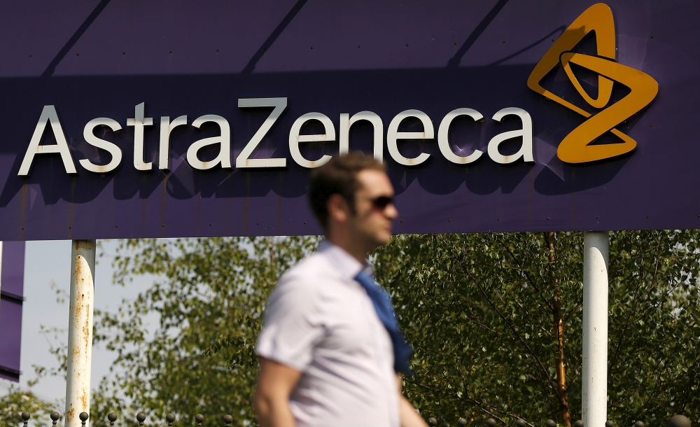A man walks past a sign at an AstraZeneca site in Macclesfield, central England May 19, 2014. REUTERS/Phil Noble/File Photo