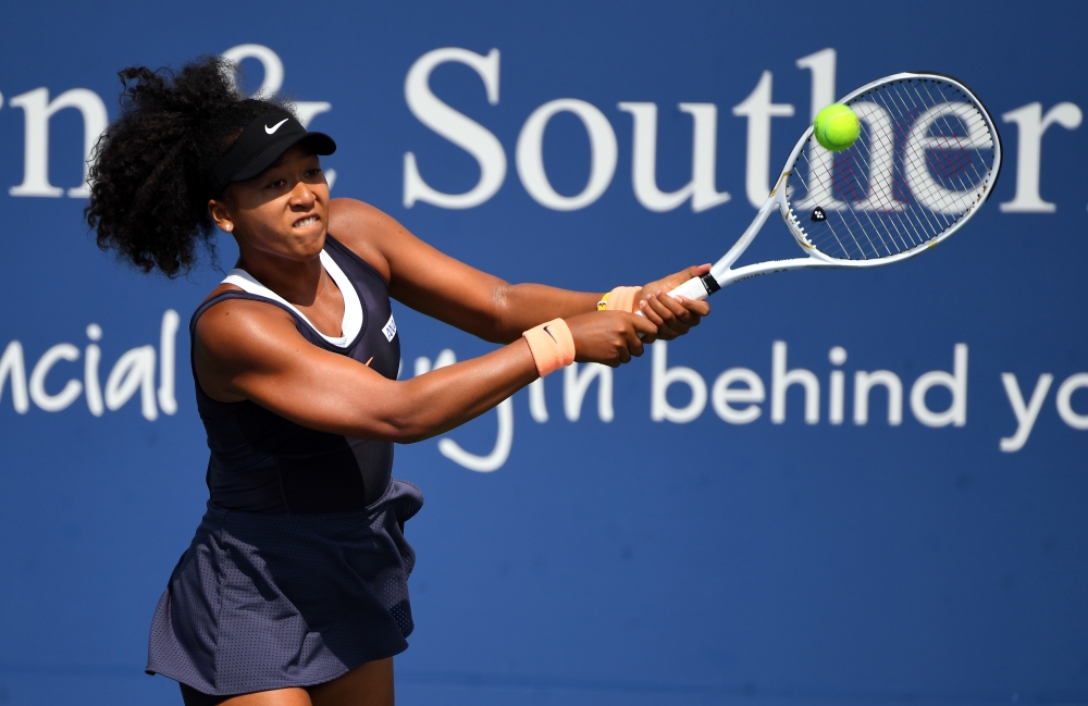 Aug 28, 2020; Flushing Meadows, New York, USA; Naomi Osaka (JPN) returns the ball against Elise Mertens (BEL) during the Western & Southern Open at the USTA Billie Jean King National Tennis Center. Mandatory Credit: Robert Deutsch-USA TODAY Sports