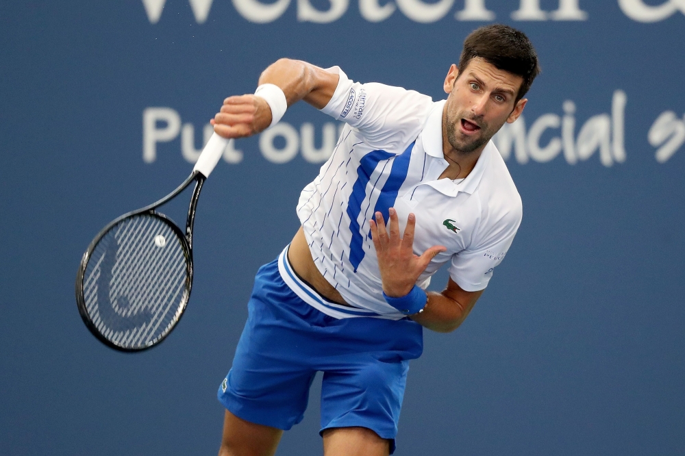 AUGUST 29: Novak Djokovic of Serbia serves to Milos Raonic of Canada in the men's singles final of the Western & Southern Open at the USTA Billie Jean King National Tennis Center on August 29, 2020 in the Queens borough of New York City. Matthew Stockman/