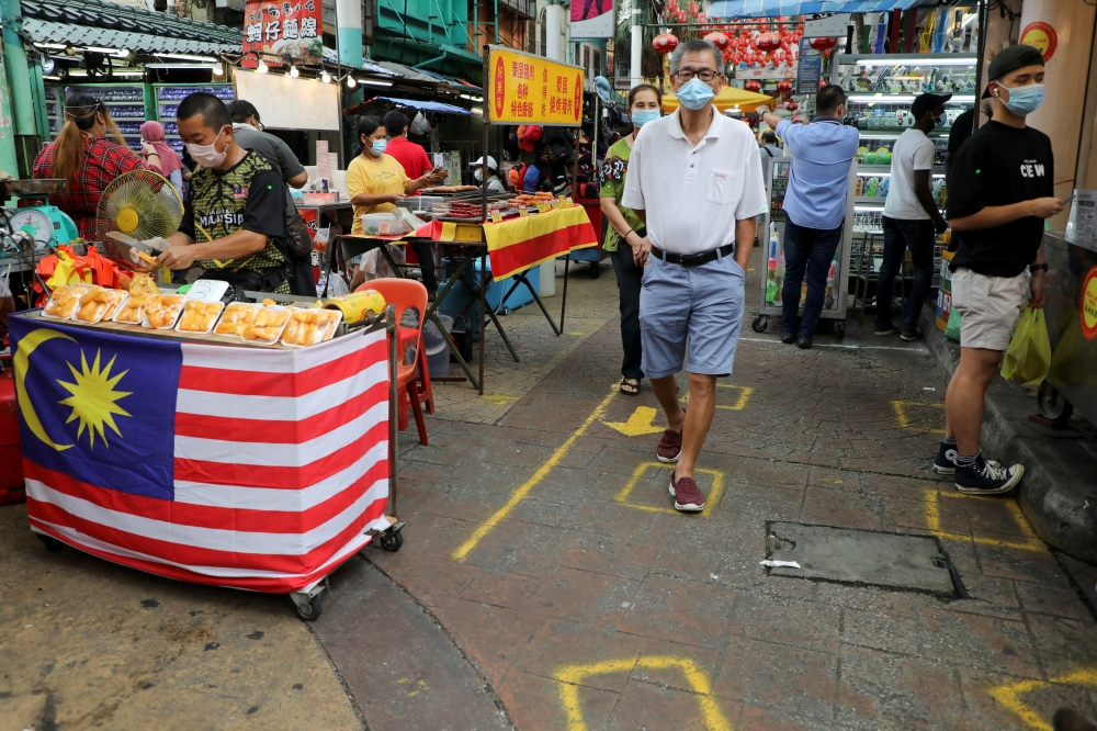 Shoppers wearing protective masks shop in Chinatown, amid the coronavirus disease (COVID-19) outbreak in Kuala Lumpur, Malaysia August 18, 2020. REUTERS/Lim Huey Teng/File Photo