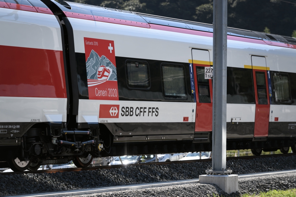 A train of Swiss Railways is seen on September 4, 2020, in Camorino, southern Switzerland, during the inauguration of the Ceneri Base railway tunnel.  / AFP / Fabrice COFFRINI