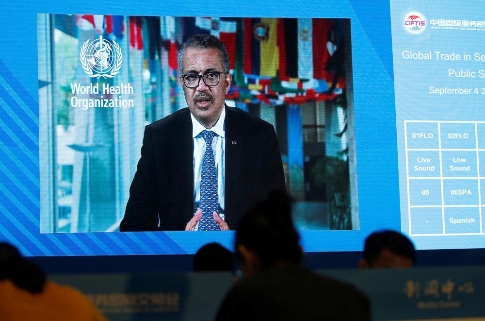A screen shows WHO Director-General Tedros Adhanom Ghebreyesus delivering a speech via video for the opening ceremony of the 2020 China International Fair for Trade in Services (CIFTIS), at a media centre in Beijing, China September 4, 2020. REUTERS/Tings