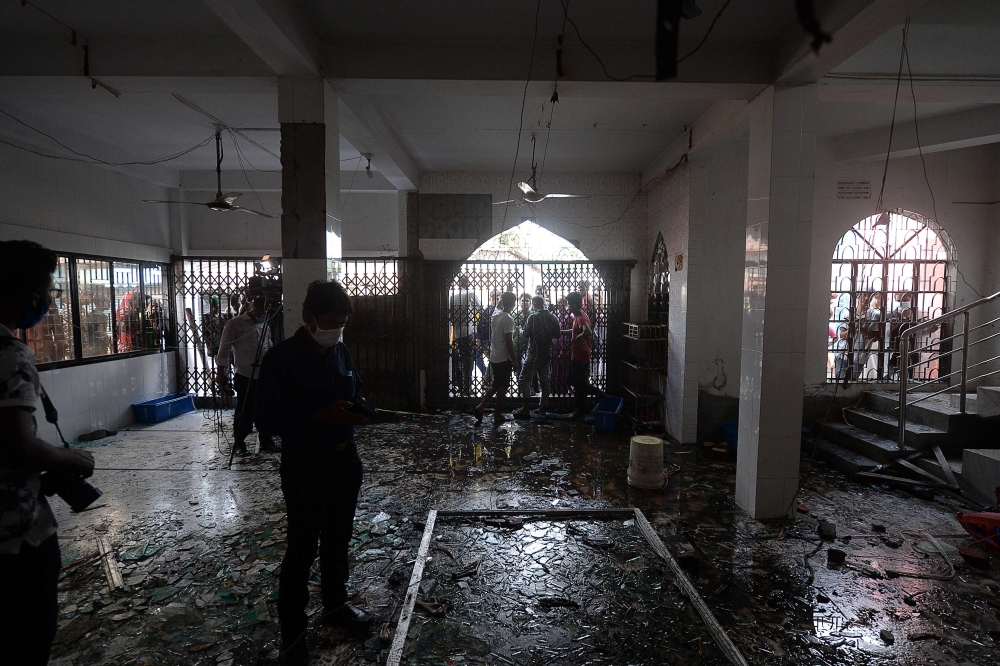 Shattered glasses are seen inside a mosque following a fire in the central district of Narayanganj, on September 5, 2020.   AFP / Munir UZ ZAMAN