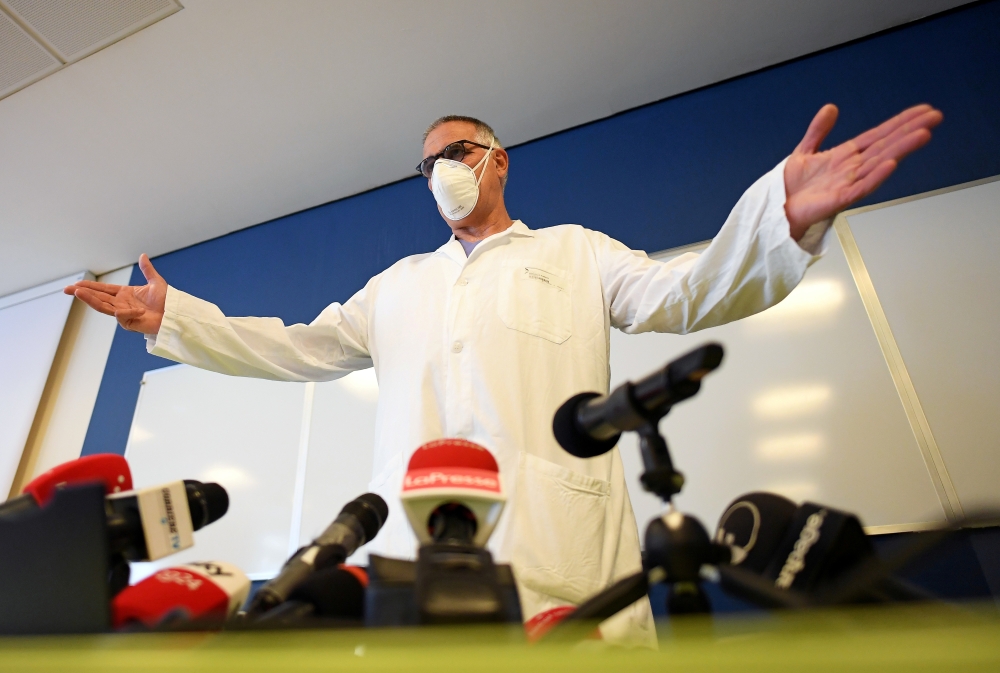 FILE PHOTO: Professor Alberto Zangrillo, head of ICU at San Raffaele Hospital, gestures as he wears a protective face mask during a news conference after Italy's former Prime Minister Silvio Berlusconi has been hospitalised for further checks after testin