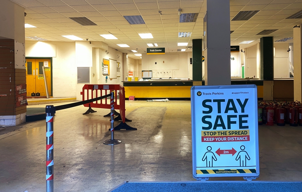 Social distancing signage is seen inside an empty branch of Travis Perkins that was closed down in Hackney, London, Britain September 8, 2020. REUTERS/Simon Newman