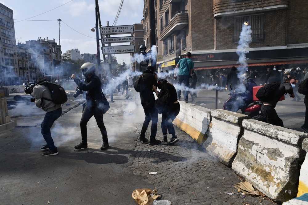 Security forces try to disperse protesters with tear gas during a demonstration called by the 
