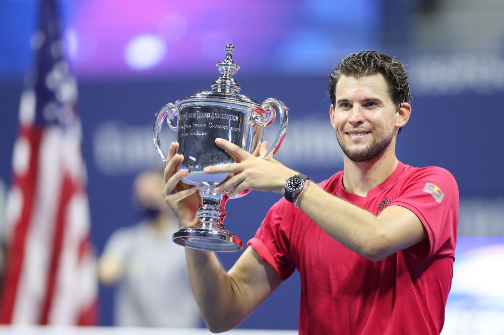 Dominic Thiem of Austria celebrates with championship trophy after winning in a tie-breaker during his Men's Singles final match against Alexander Zverev of Germany on Day Fourteen of the 2020 US Open at the USTA Billie Jean King National Tennis Center on