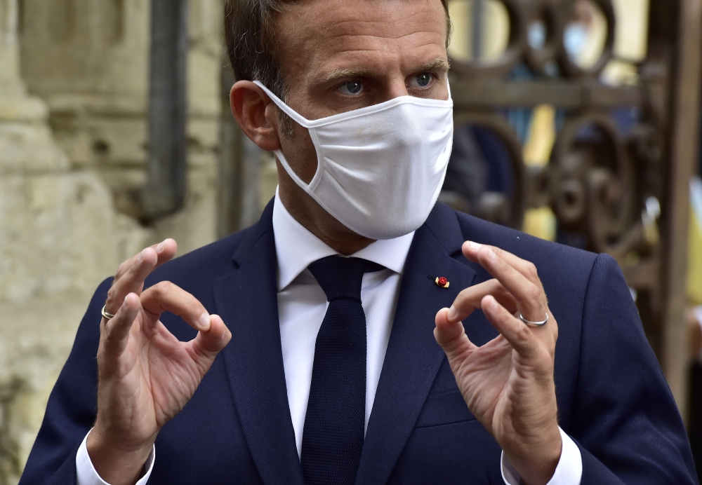 French President Emmanuel Macron wearing a protective face mask speaks to journalists during a visit at the Polignac castle on September 18, 2020 in Condom, on the eve of the European Heritage Days and the third edition of the 