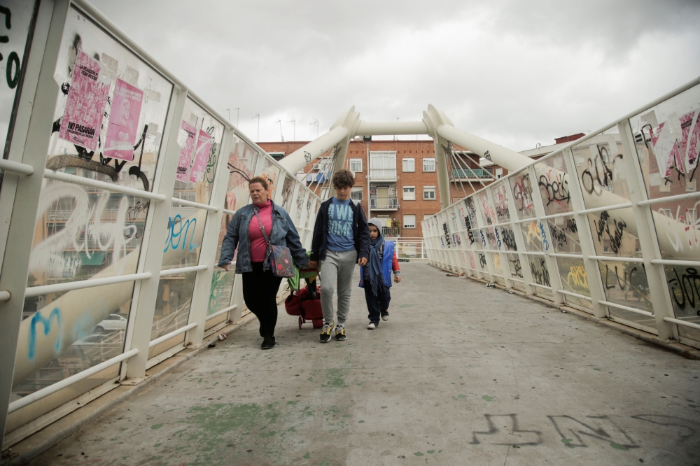 People walk at Puente de Vallecas neighbourhood, amid the outbreak of the coronavirus disease (COVID-20) in Madrid, Spain, September 20, 2020. REUTERS/Javier Barbancho