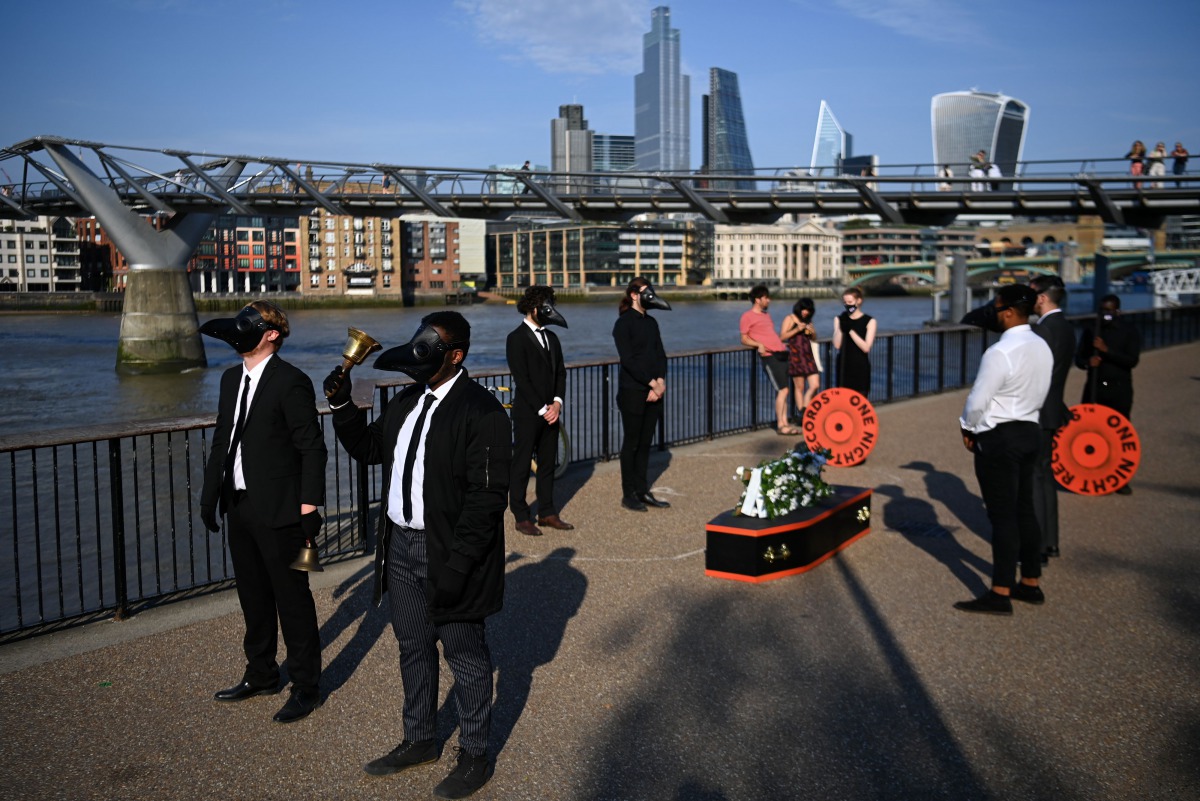 Musicians perform a staged funeral for the 