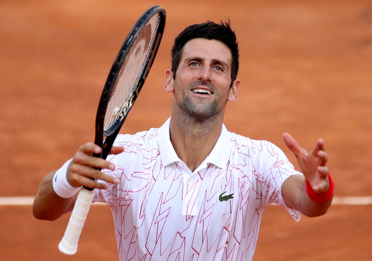 TOPSHOT - Serbia's Novak Djokovic celebrates after victory over Norway's Casper Ruud in their semi final match of the Men's Italian Open at Foro Italico in Rome on September 20, 2020. / AFP / POOL / Clive Brunskill
