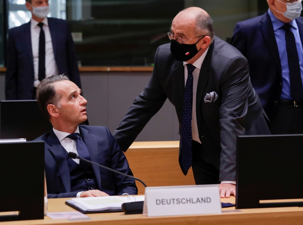 German Foreign Minister Heiko Maas chats with Polish counterpart Zbigniew Rau during a foreign affairs ministers council in Brussels, Belgium September 21, 2020. Olivier Hoslet/Pool via REUTERS