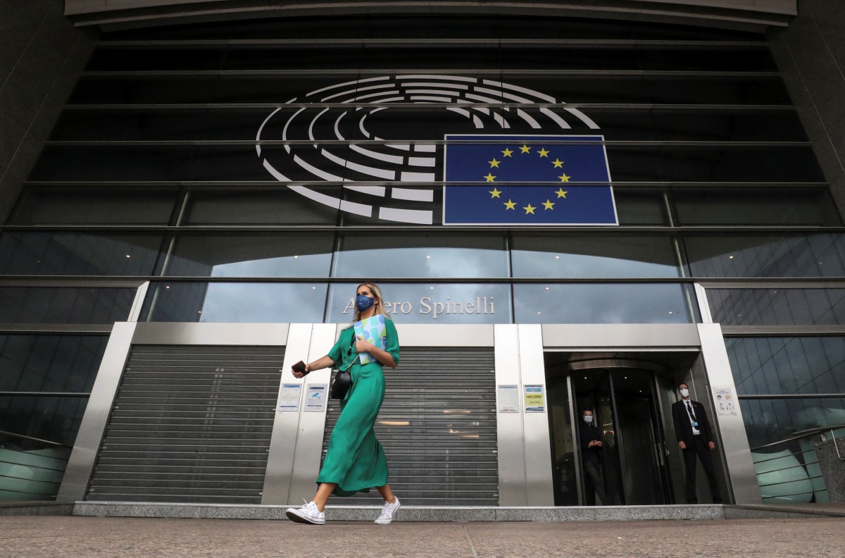 A woman wearing a protective mask leaves the European Parliament headquarters amid the coronavirus disease (COVID-19) outbreak in Brussels, Belgium September 23, 2020. REUTERS/Yves Herman

